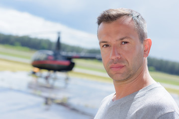 pilot on airfield with helicopter © auremar