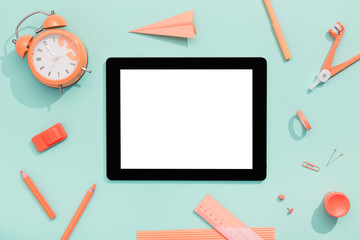 Back to school concept. Blank tablet with school and office supplies on office table. Flat lay with copy space.
