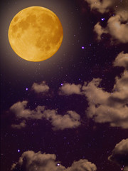 Full yellow moon with star at dark clouds night sky background