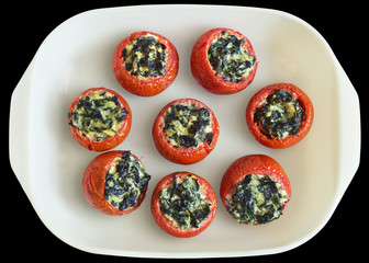Tomatoes Stuffed With Spinach In White Ceramic Baking Pan Isolated On Black Background