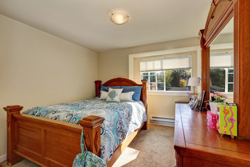 Nice wooden carved bed with colorful bedding