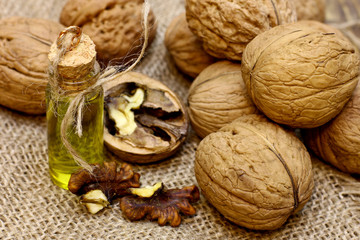 Vintage bottle walnut oil and nuts on coarse cloth sacking