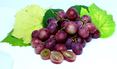Red rose grapes bunch natural organic berry and autumn green grape leaves isolated on white background.