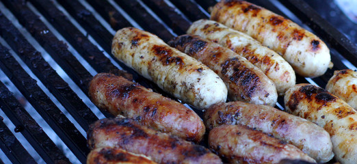 Red baked delicious sausages in row fastfood grill in grillbar roasted for hot dog