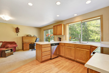 Wooden kitchen room interior with modern steel appliances.