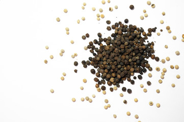 Pile of black and white pepper on white background. 