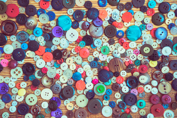 clothes buttons on wooden baclground