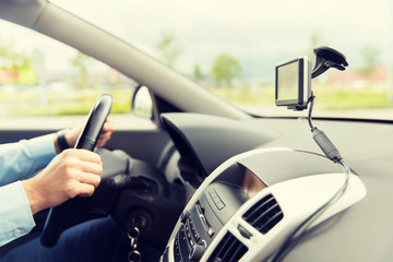 Naklejka premium close up of man with gps navigator driving car