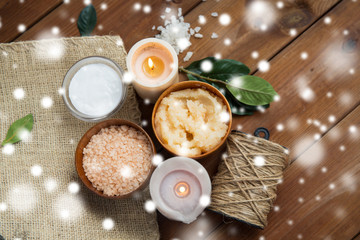 natural body scrub and candles on wood