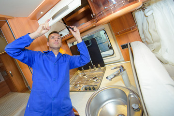 Mechanic working on interior of camper van