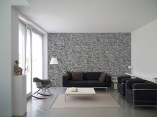 living room interior with natural stone wall and copy space for images, photos and paintings