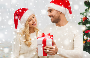 happy couple at home with christmas gift box