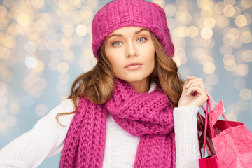 happy woman in winter clothes with shopping bags