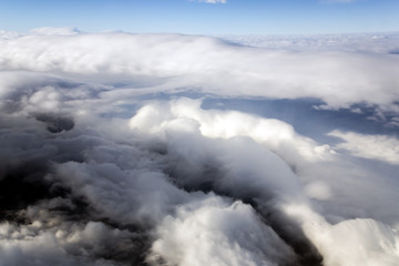 Blue sky and puffy clouds on height of 5000 m above Earth