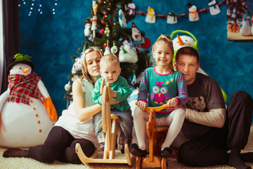 Loving parents hug their childred while they sit on the wooden t