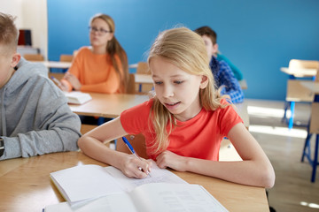 Fototapeta premium student girl with book writing school test