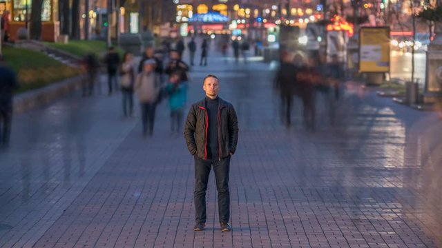 3 in 1 video! The man stand in crowd flow. Evening night time. Time lapse
