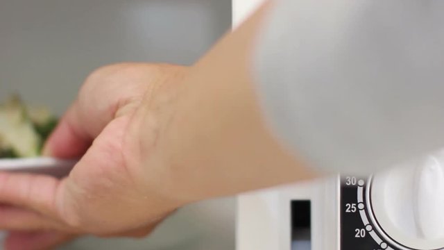 footage closeup hand using a microwave to cook and defrost food, Thailand, real time 