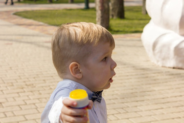 Boy in shirt is playing in park