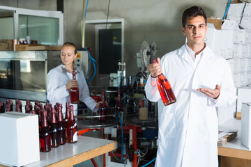 man and woman working on wine production