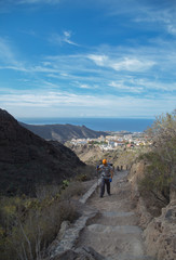 Backpacker man hiking in beautiful landscapes of Barranco del Infierno in Tenerife. Canary islands, Spain