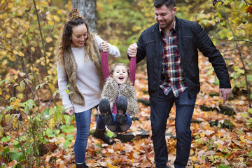 Naklejka na ściany i meble Happy family outdoor in park at autumn.