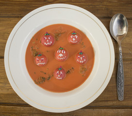 Halloween lunch . Pumpkin soup on the plate .