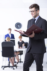 Elegant man reading documents at office