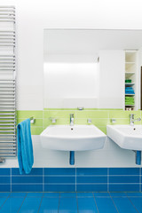 Naklejka na ściany i meble Blue and white bathroom with two sinks
