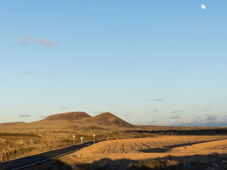 Remote road at sunset in the dessert of the island Fuerteventura