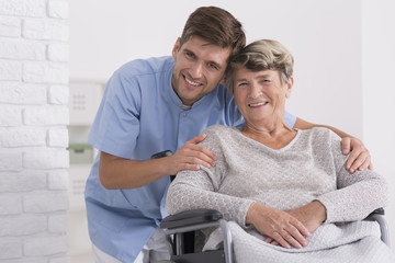 Male nurse hugging his senior woman patient