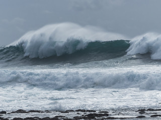 Massive surf at the Atlantic sea rolling in to the beach.