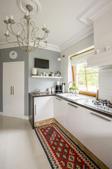 Open plan kitchen with patterned carpet