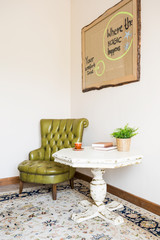 Green leather armchair and table