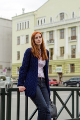 Young red woman walking in the city