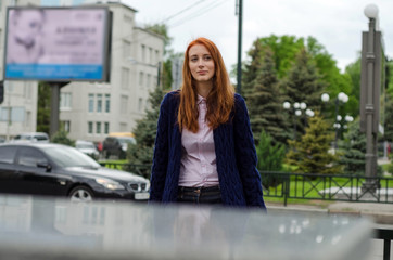 Young red woman walking in the city