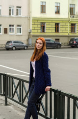 Young red woman walking in the city