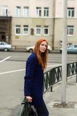 Young red woman walking in the city