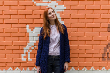 Young red woman walking in the city