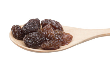 raisins in spoon on white background.