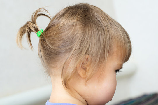 first hair style: tiny ponytail, profile of baby girl Stock Photo | Adobe  Stock