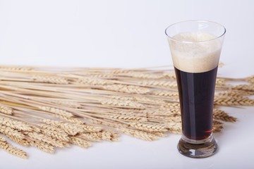 Black beer in the glass on the table