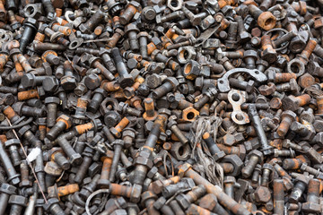 Old and used nuts and bolts on dirty and grunge cement floor