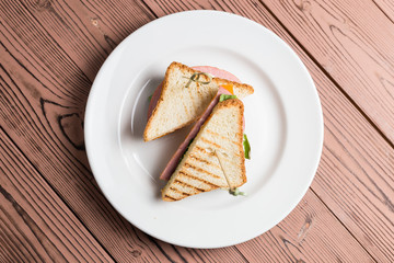Club sandwich with salmon on white plate