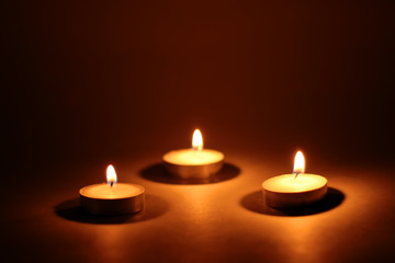 Burning candles on dark background