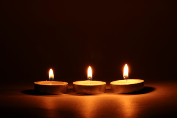 Burning candles on dark background