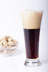 Black beer in the glass on the table