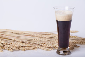 Black beer in the glass on the table
