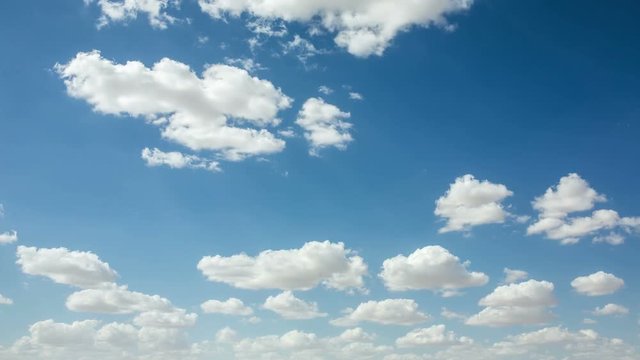 4K time-lapse of white clouds moving across a blue sky
