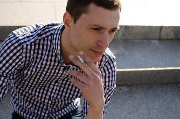 Young man smoking cigarette 